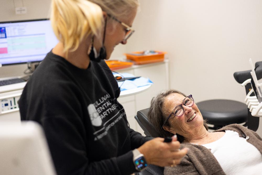 Older woman smiling in dental chair, brentwood tn
