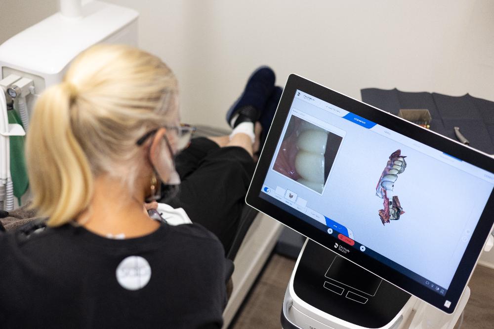 Dentist showing a patient a diagram of a dental implant, nashville tn