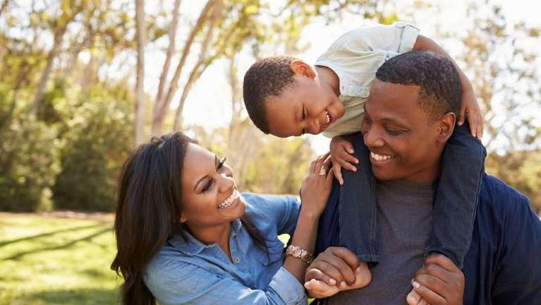 Black family hugging and smiling together, brentwood tn