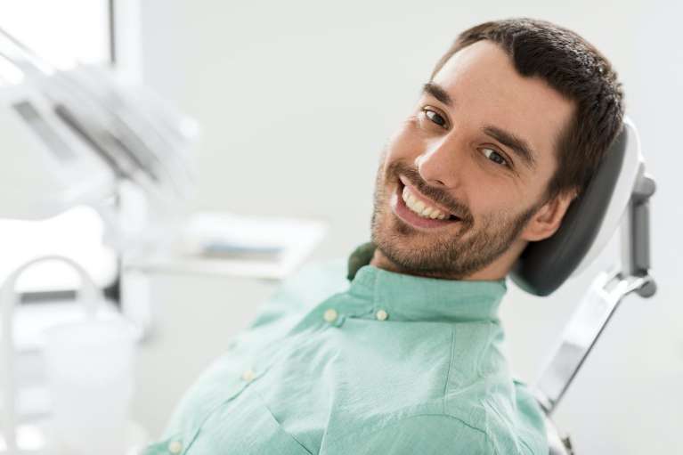 Man with brunette hair smiling in dental chair, nashville tn