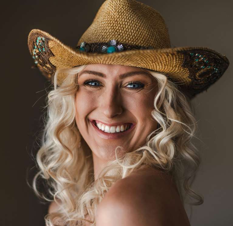 Blonde girl in cowboy hat smiling, nashville tn